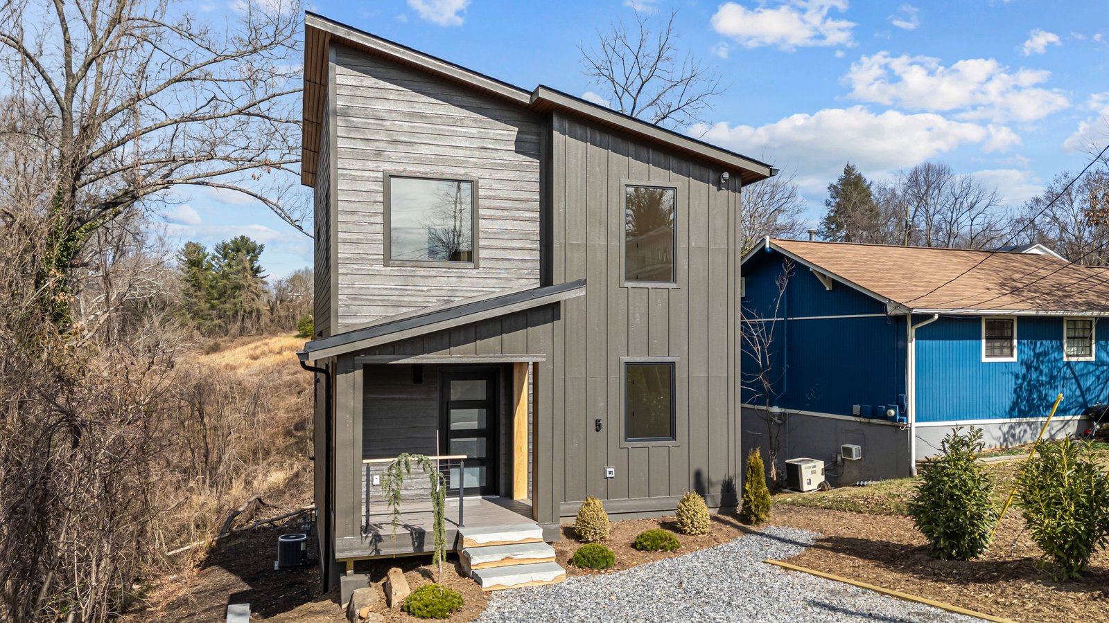 Context-responsive hillside house in West Asheville designed for a narrow sloping site